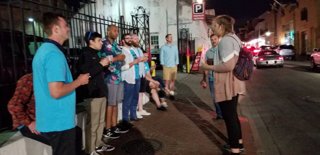 A tour group listens to a guide on Unique NOLA's Our Favorite Ghosts tour New Orleans