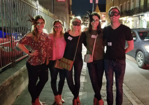 Group of people after a ghost tour new Orleans with mardi gras masks on